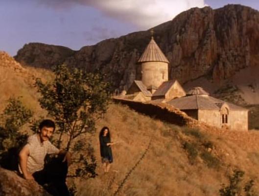 A still from Atom Egoyan's film "Calendar" showing two of the characters in front of an Armenian church